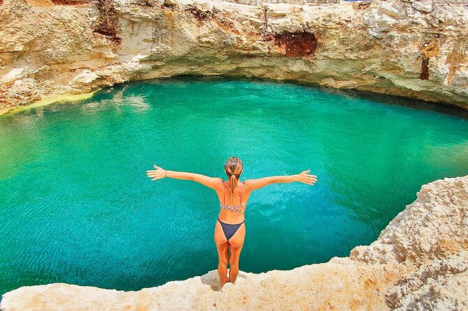 Swimmer in an open cenote in the jungle inland from Cancún