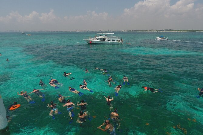 Isla Mujeres Full Day Tour on Yacht with Snorkel and Buffet - Music, games, and the sunset ride back