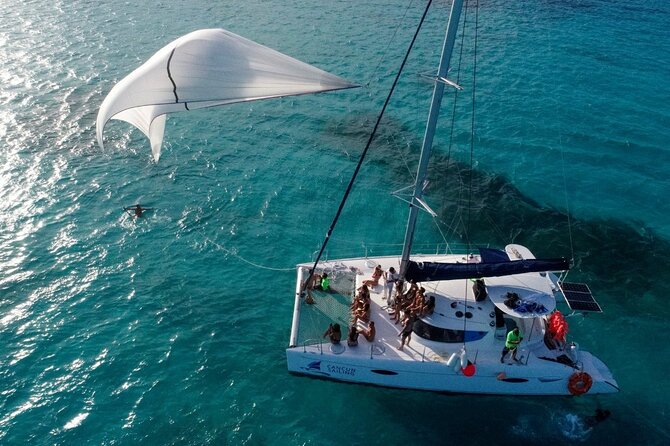Isla Mujeres Tour on Catamaran with Snorkel, Open Bar, Buffet & Beach club - The ride to Isla Mujeres: music, drinks, and social energy